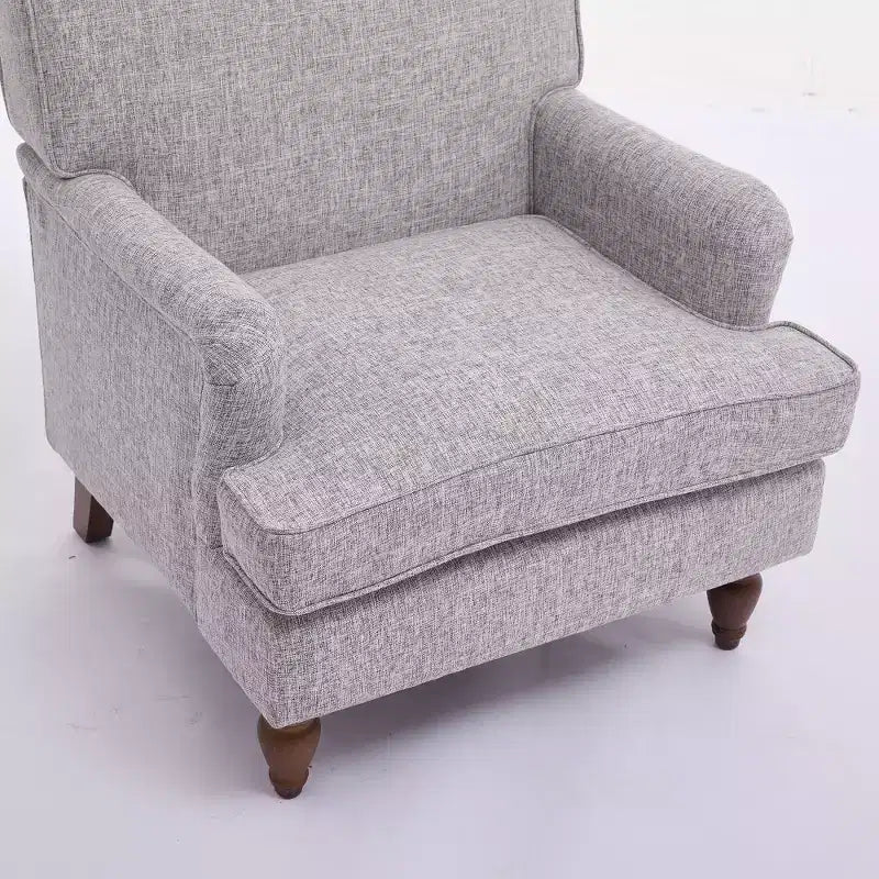 Fauteuil vintage en lin avec accoudoirs tapissés et pieds en bois massif ancien
