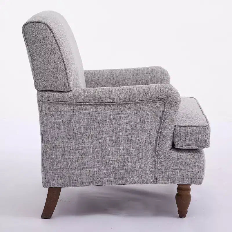 Fauteuil vintage en lin avec accoudoirs tapissés et pieds en bois massif ancien